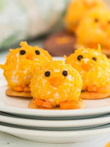Baby chick mini cheese balls on a stack of plate.