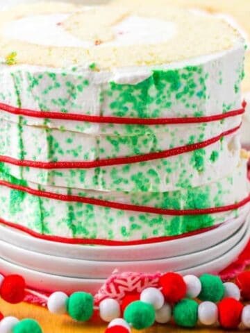 An image of a slice of Christmas roll cake on a serving plate.