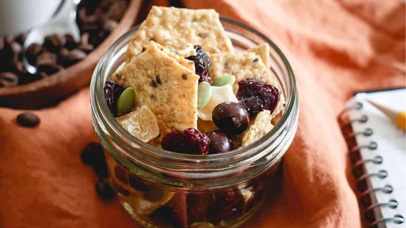 Close-up image of coffee house cracker crunch trail mix in a glass jar.