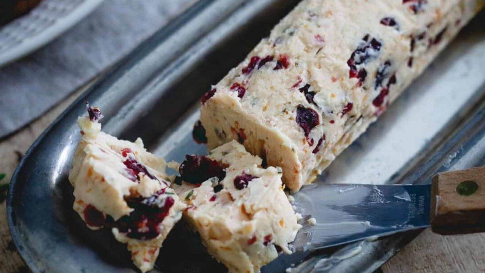 Close-up image of sliced cognac cranberry orange compound butter.
