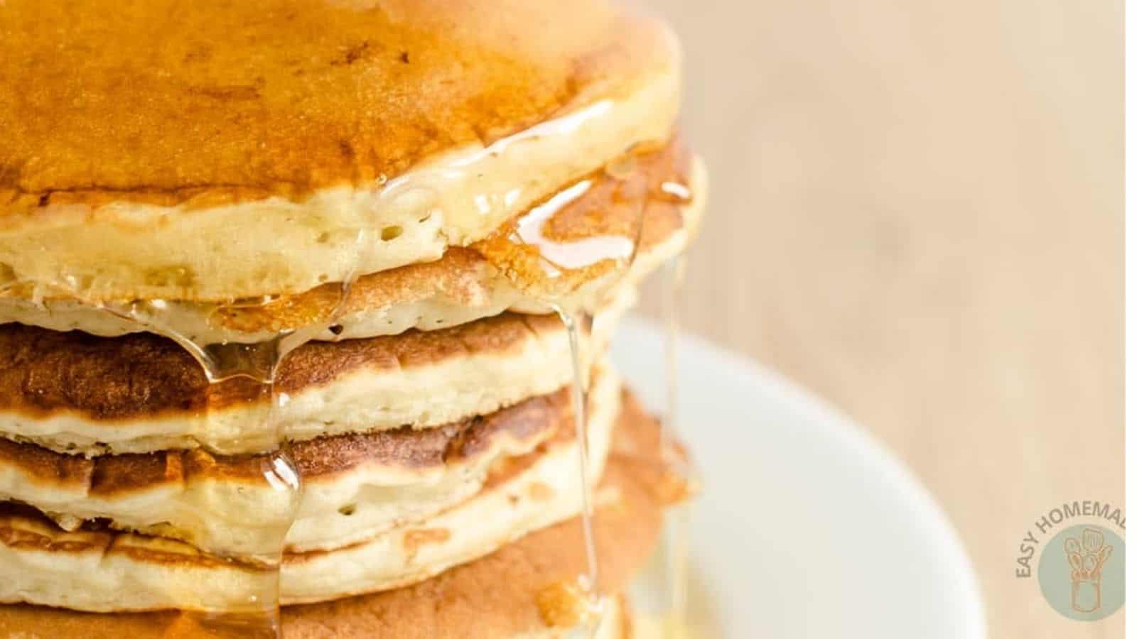 A stack of McDonald’s Pancake Recipe with syrup drizzling down.