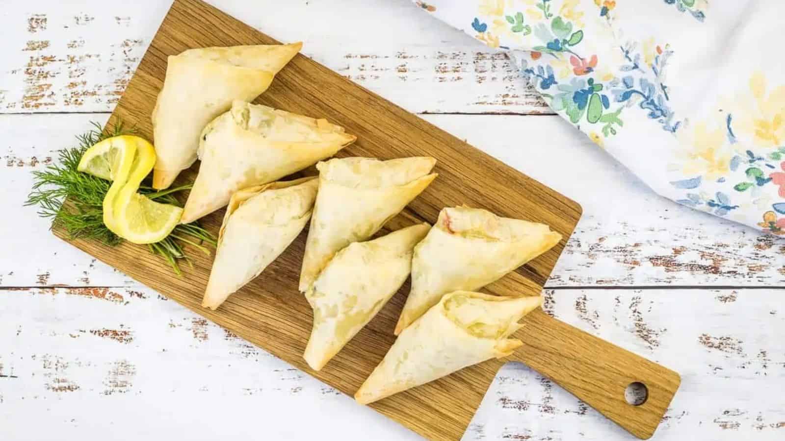 Crab Spanakopita on a wooden board.