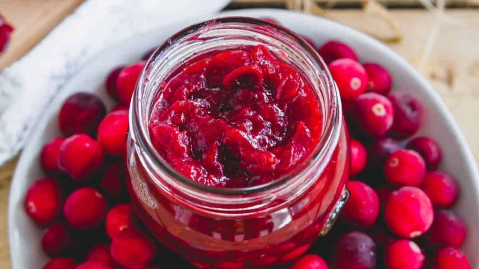 Close-up image of cranberry ginger jam in a jar.