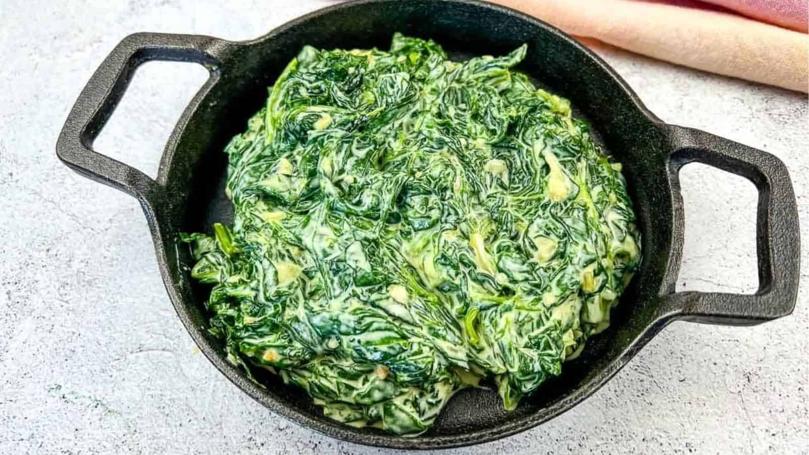 Creamed Spinach with Mascarpone in a black dish.