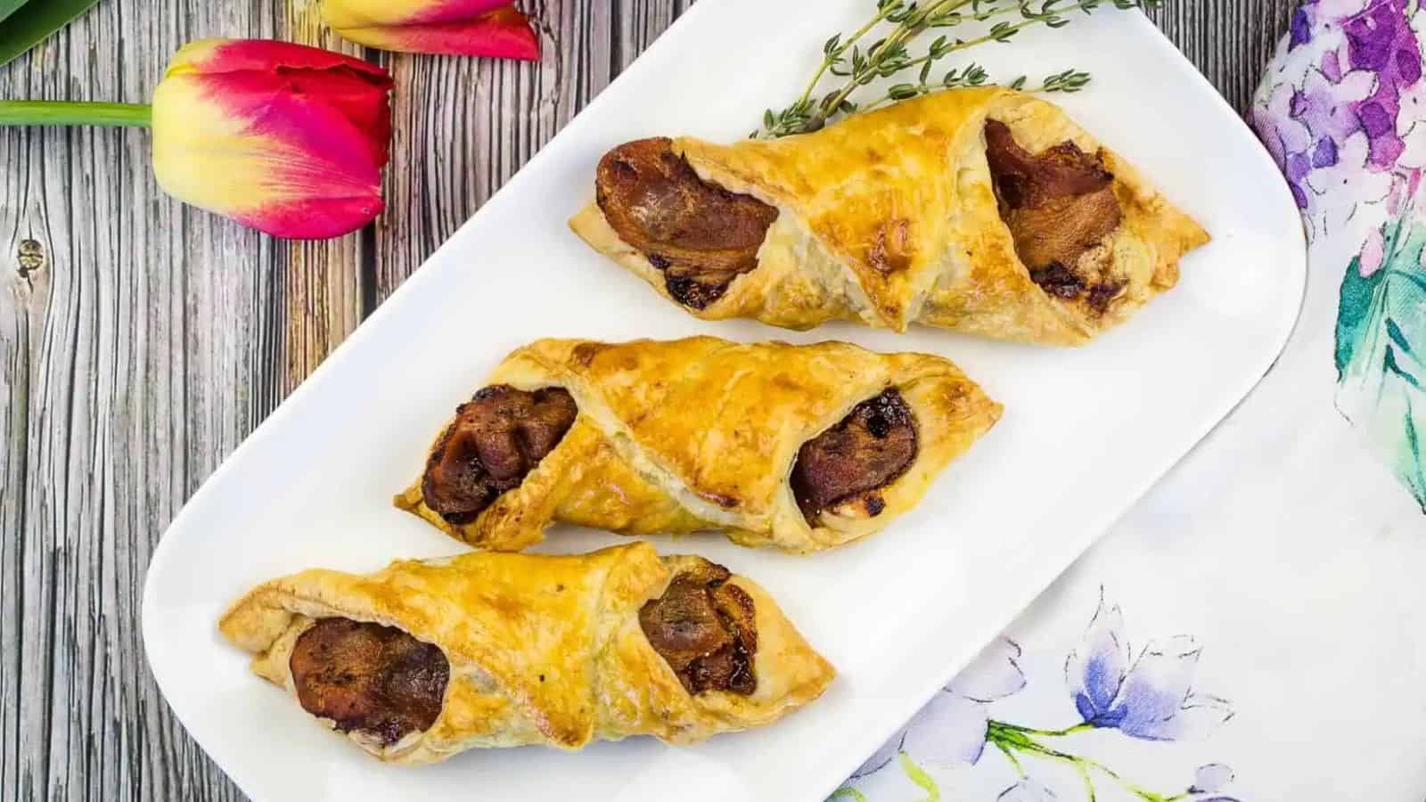 Three Flaky Cheese and Bacon Turnovers on a plate.