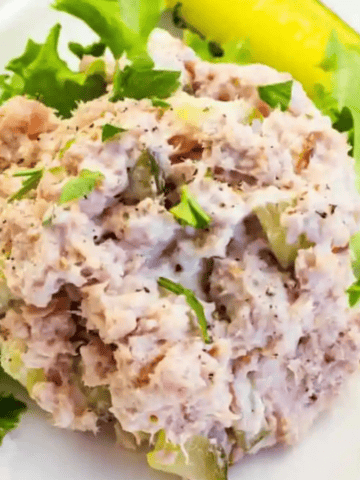 Ham Salad with Pickle on top of lettuce.