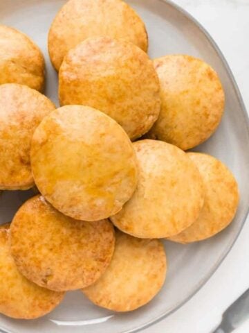An overhead image of a stack of biscuits on a plate.