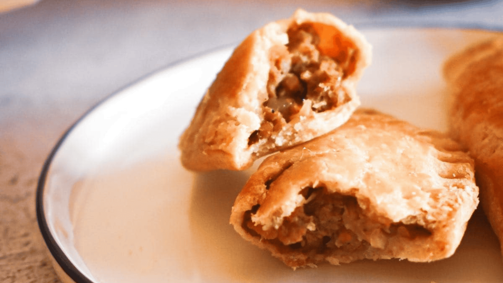 A tray of pasties on a cooling rack.