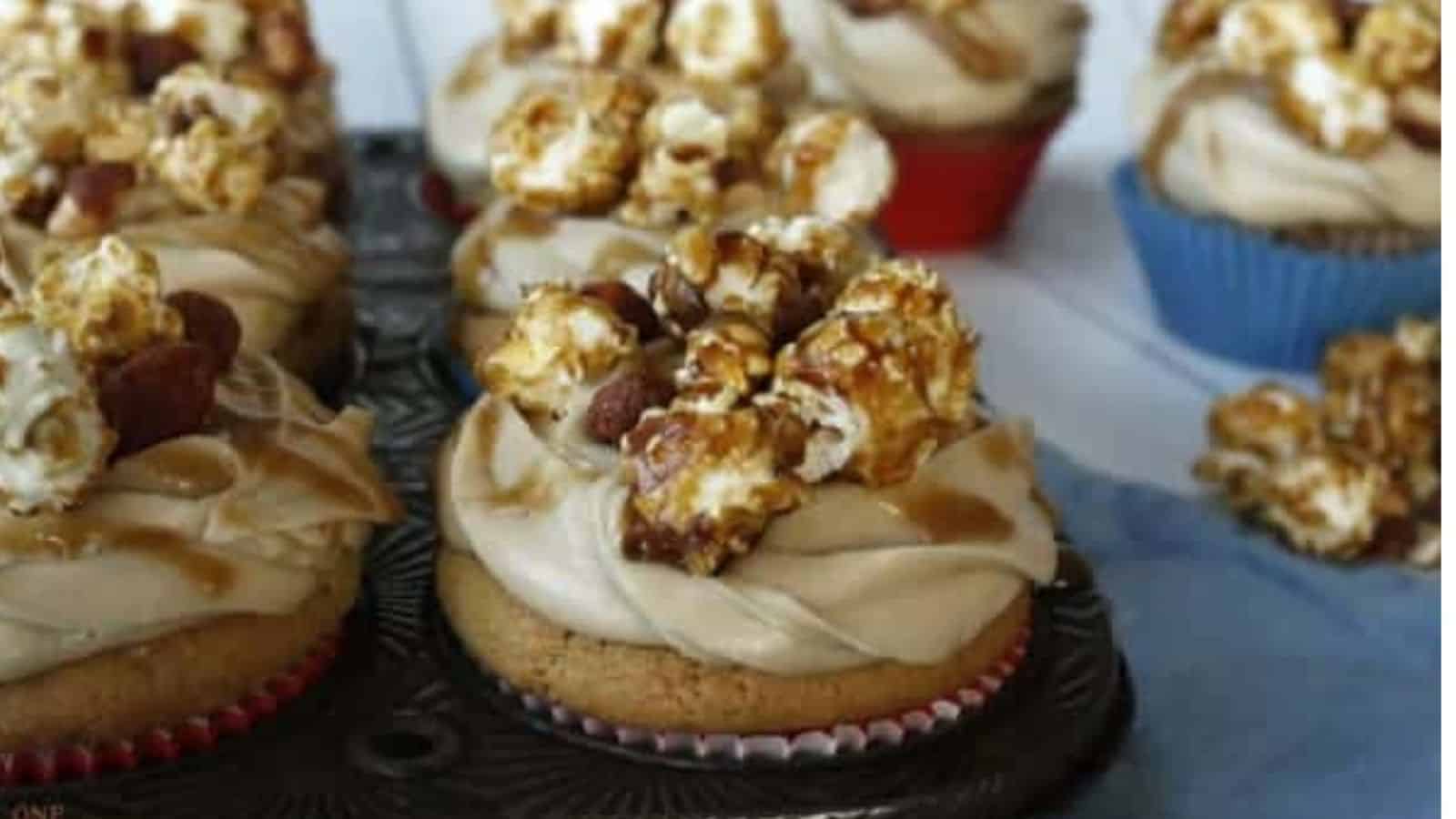 Close-up image of peanut butter cupcakes with caramel frosting and cracker jack.