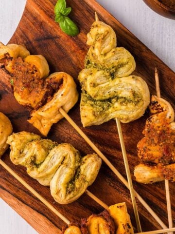 Pesto Puff Pastry Christmas Tree Appetizer on a wooden board.