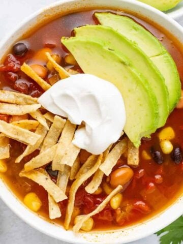 Top view of a bowl of slow cooker tortilla soup.