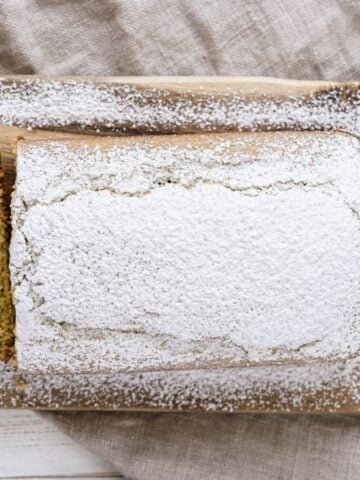 Top view of Vegan Lemon Poppyseed Cake on a wooden board.