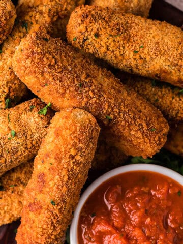 An overview of Air Fryer Chicken Mozzarella Sticks with a dip.