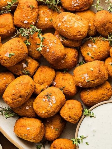 An overview of a plate full of Air Fryer Sweet Potato Tater Tots with a dip.