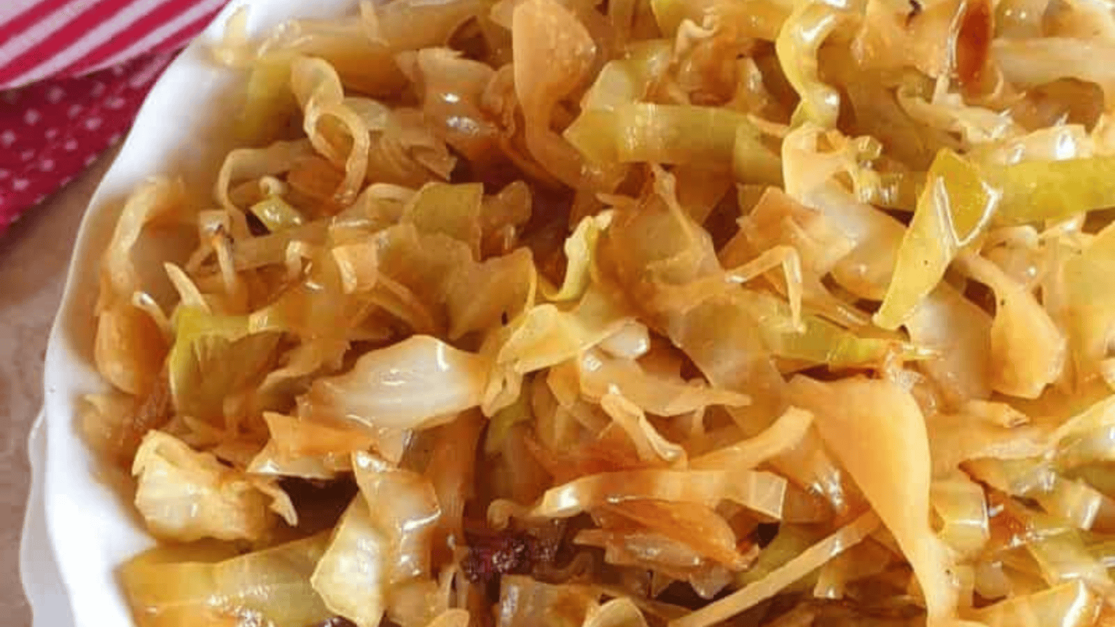Braised cabbage in bowl with spoon.
