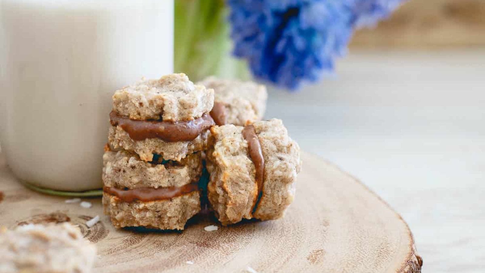 An overview of Eggless Banana Pancakes with Fennel Seeds on a stack of plates with flowers.