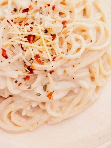 An overview image of Creamy One-Pot Garlic Parmesan Pasta on a plate with a fork.