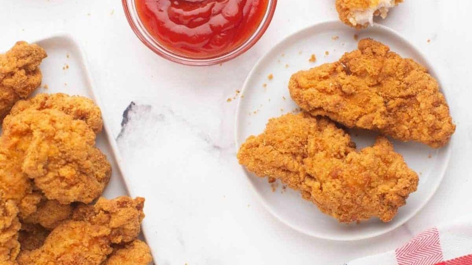A plate of Frozen Chicken Tenders in the Air Fryer with a dip.