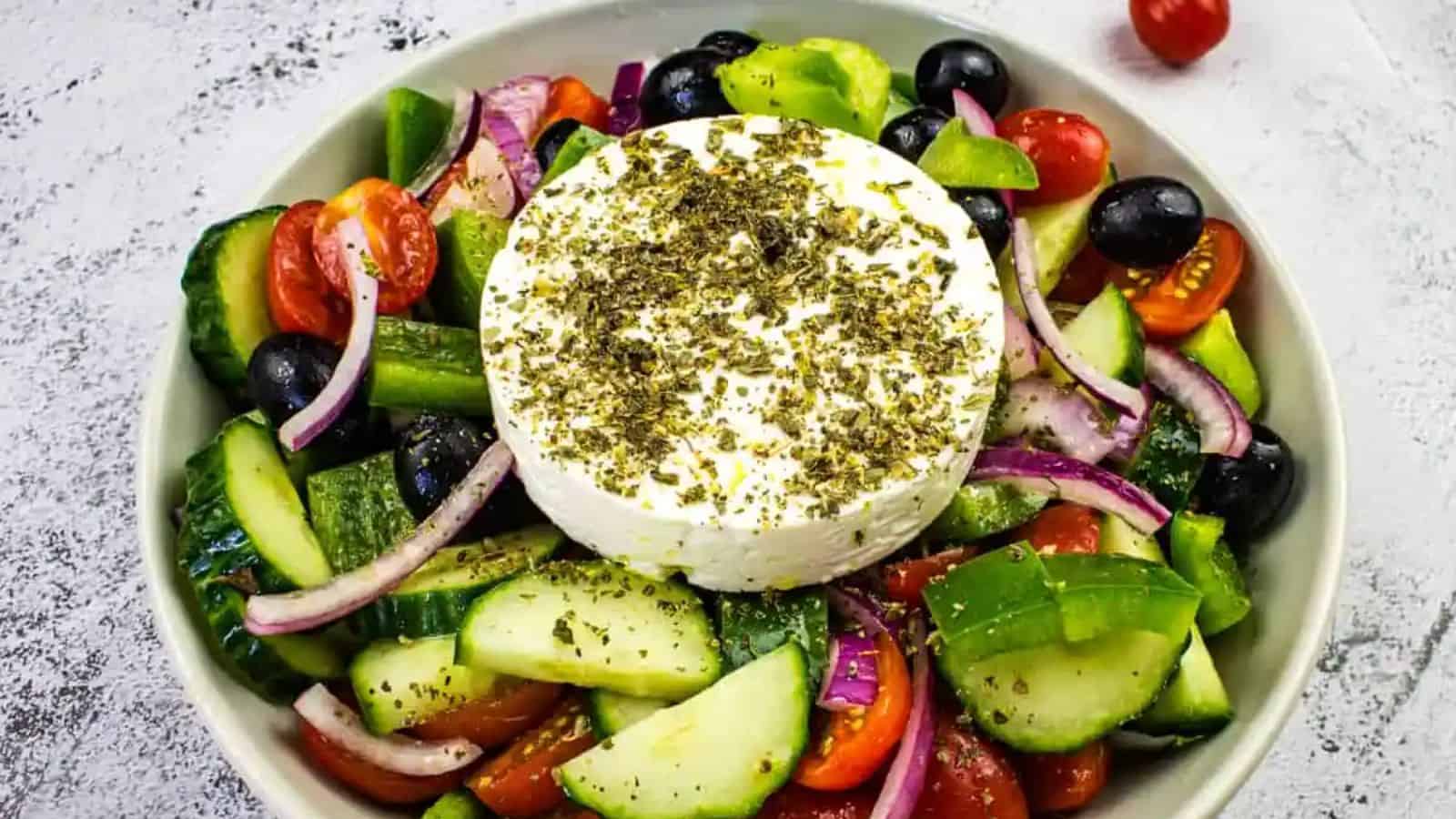 Mediterranean cucumber salad in a blac bowl.