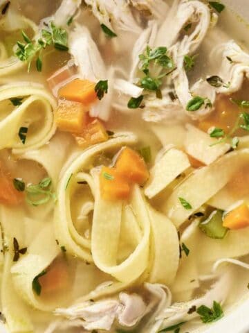 Close-up view of a bowl of Homemade Chicken Noodle Soup.