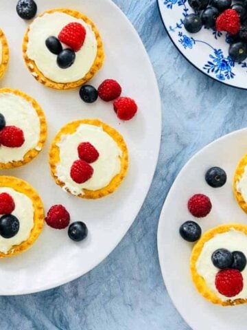 Top view of plates full of Mini Shrikhand Tart with Berries.