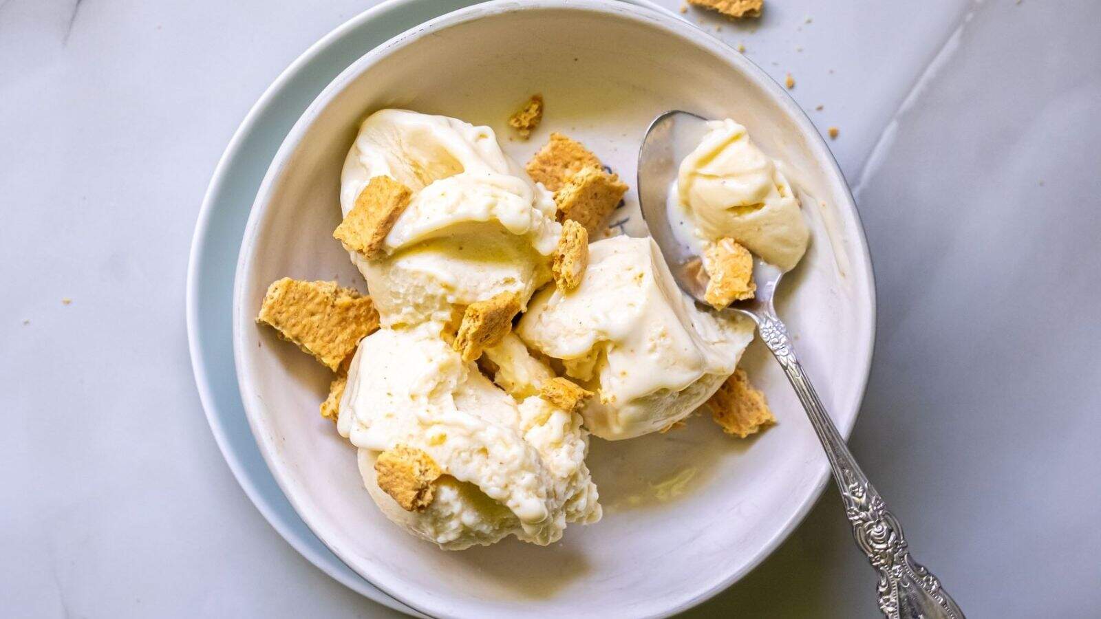 A bowl of Ninja Creami Banana Cheesecake Ice Cream with a spoon.