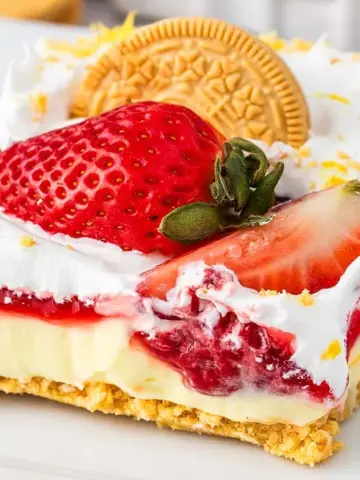 A slice of Strawberry Lemon Cheesecake Lasagna on a plate.