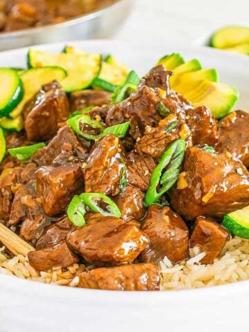 A bowl of rice with Teriyaki Steak Bites on top.