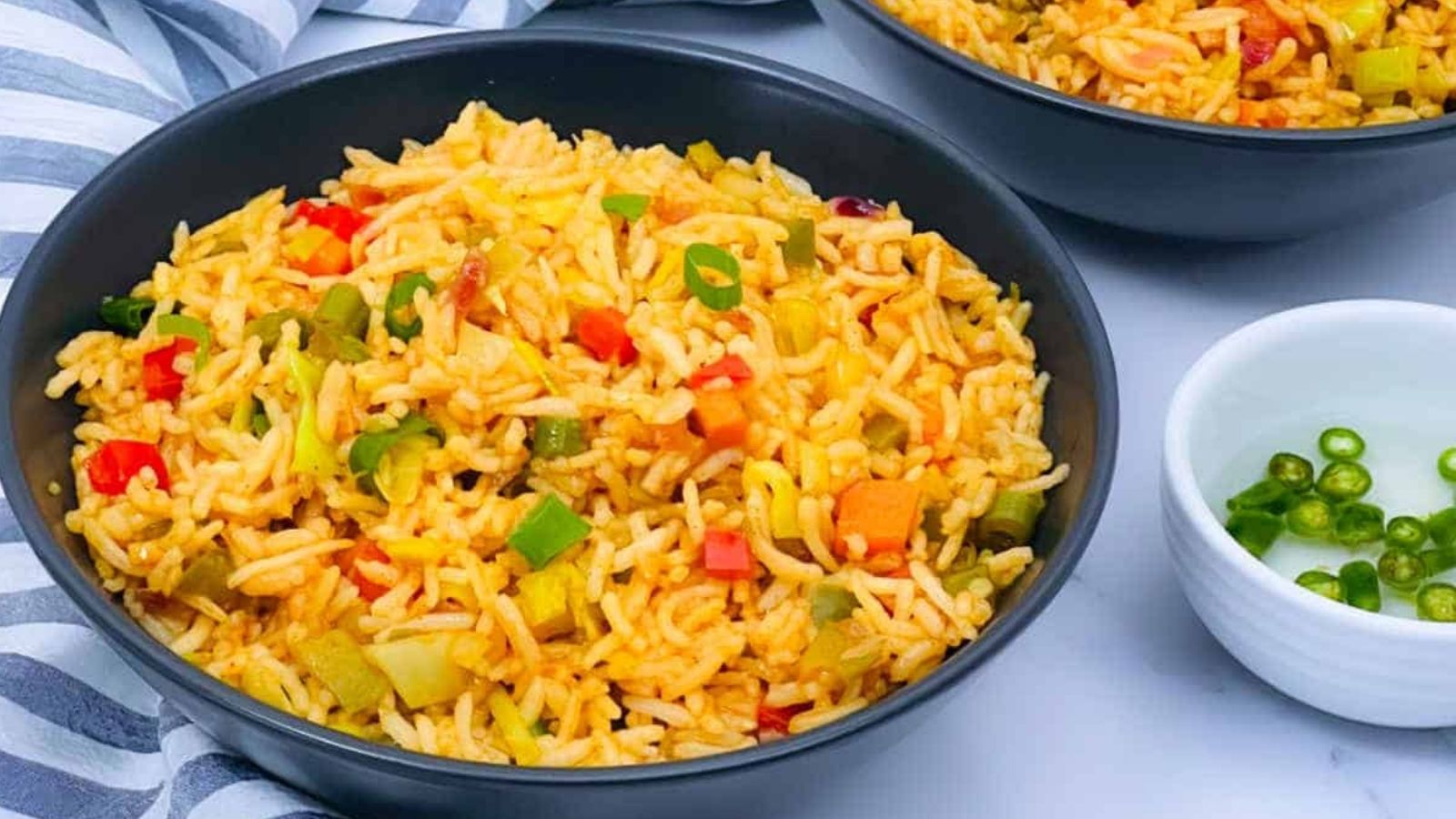Close-up image of a bowl of vegetable fried rice.