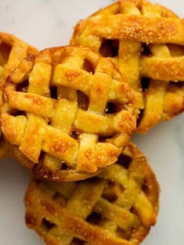 An overhead image of a stack of mini apple pies.