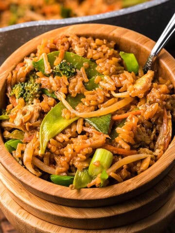 PF Chang's Fried Rice on a stack of wooden bowls.