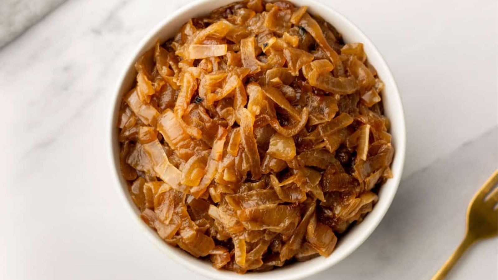 An overhead image of slow cooker caramelized onions in a bowl.