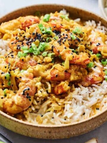 A bowl of rice topped with Thai Coconut Shrimp Curry.