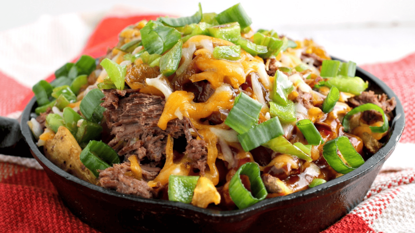 Irish Pub-Style Potato Nachos in a skillet pan.