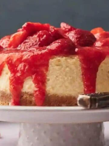 An image of a whole strawberry cheesecake.