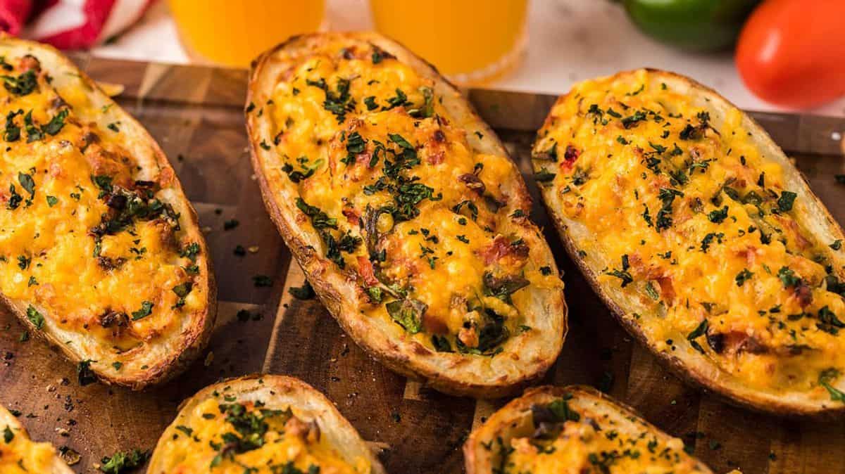 An image of Air Fryer Twice Baked Breakfast Potatoes on a wooden board.