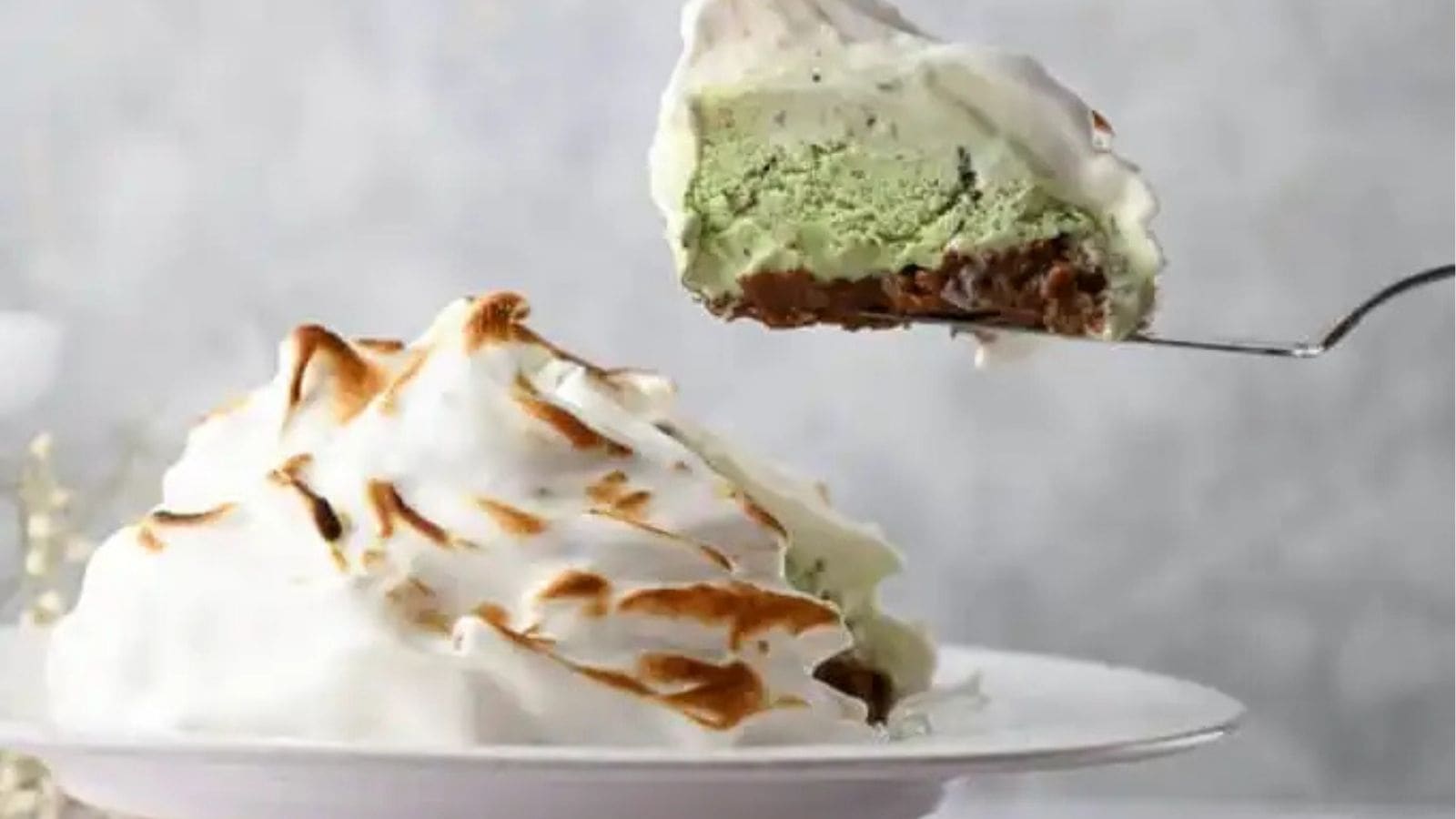 Close-up image of a slice of Baked Alaska being lifted.