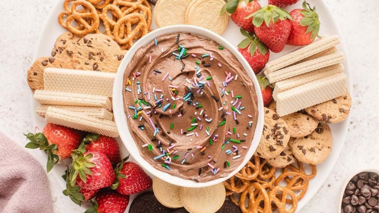 Overhead image of brownie batter dip with fruits and crackers.