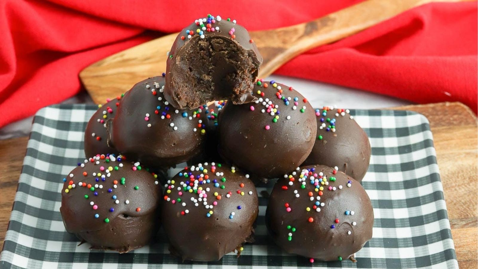 Close-up image of a stack of brownie truffles on a plate.