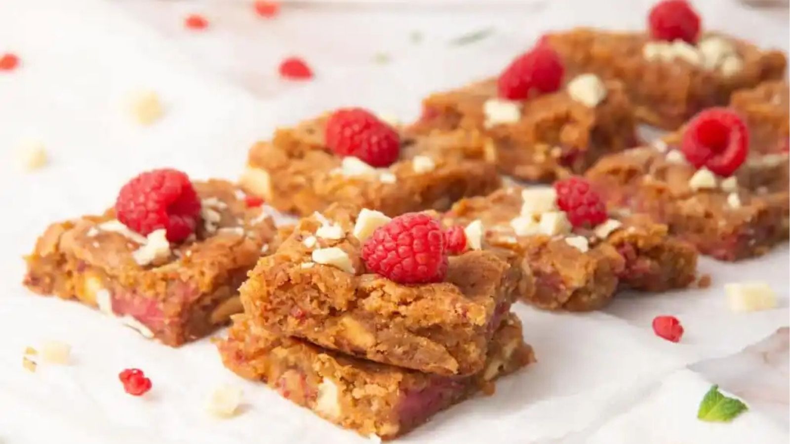 Close-up image of chewy raspberry and white chocolate blondies.