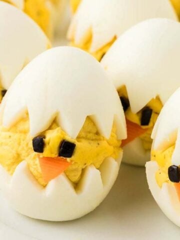 Close-up image of deviled egg chicks on a plate.