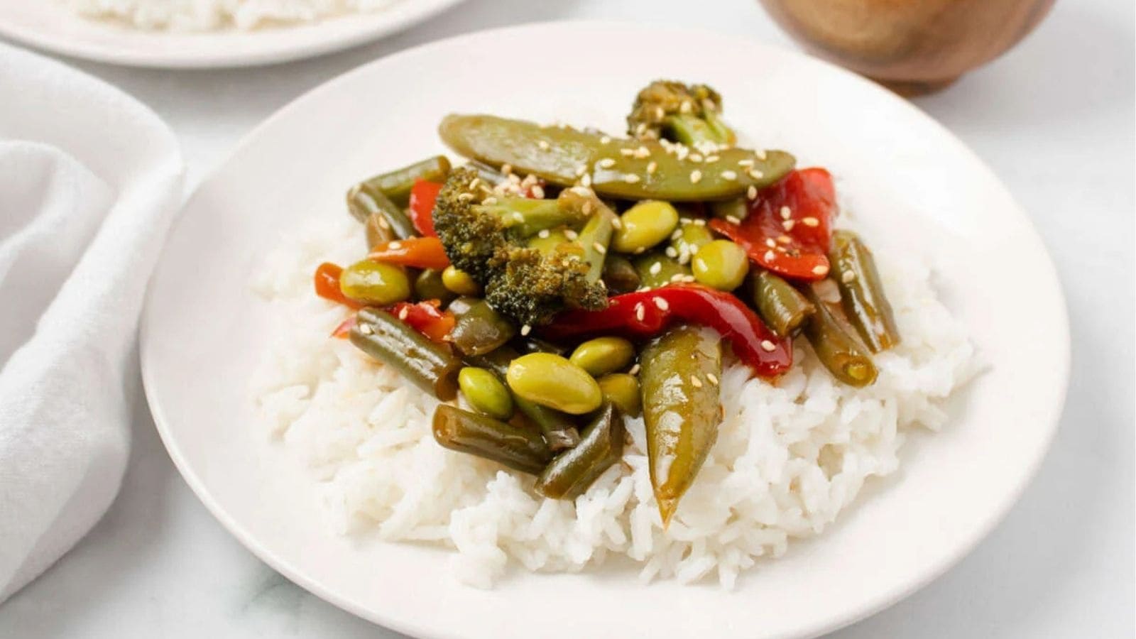 A close up image of frozen vegetable stir fry served over rice.