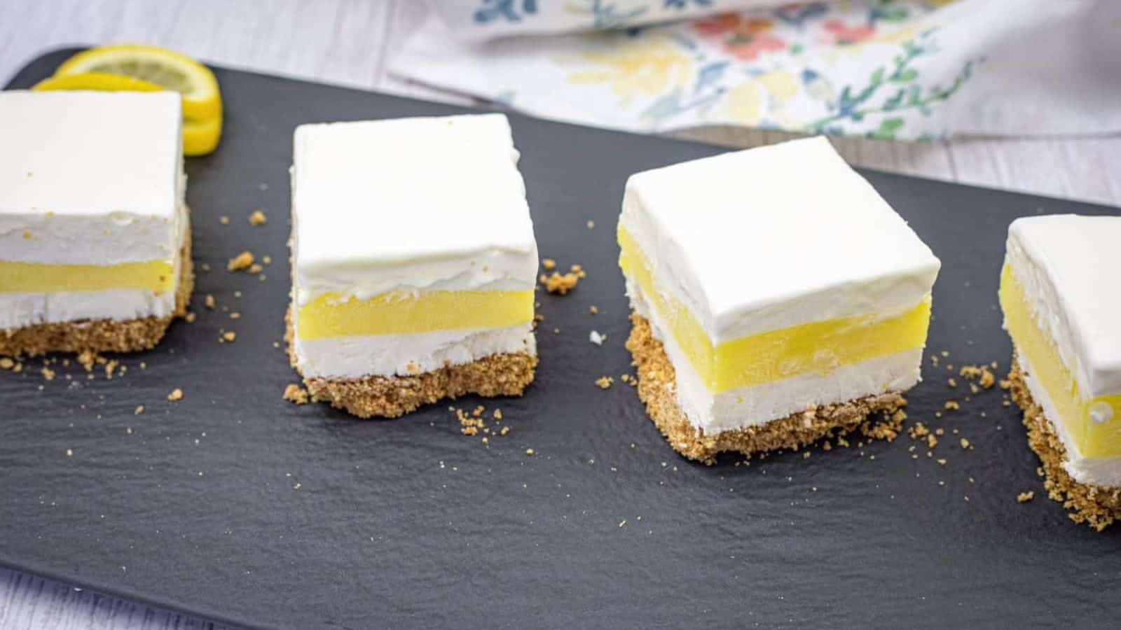 Close-up pieces of lemon lush on a slate plate.