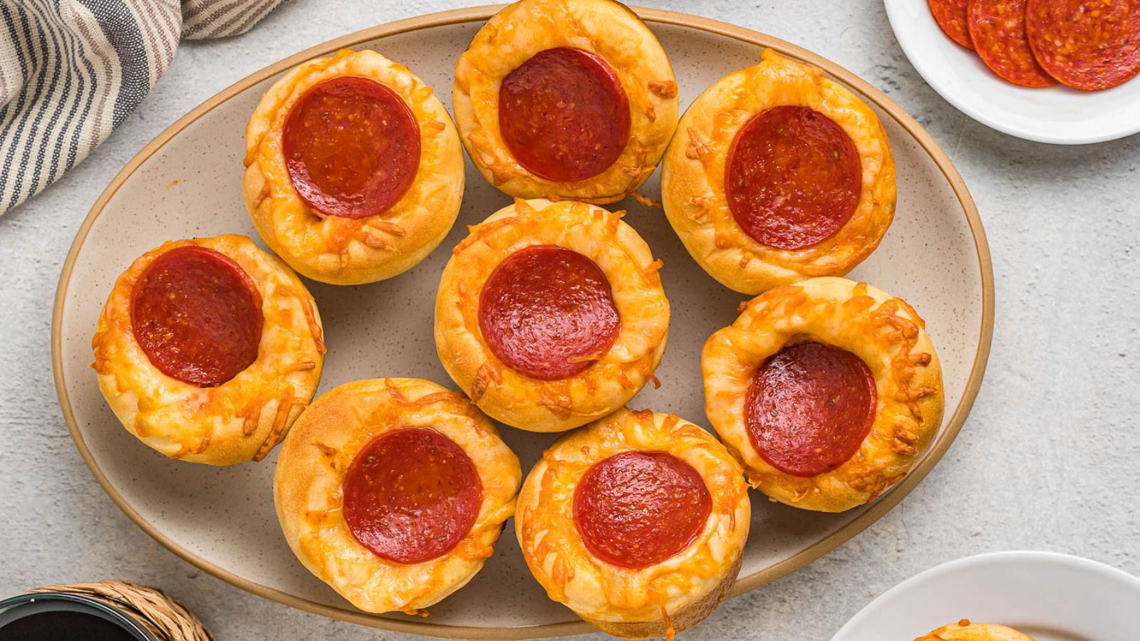 Pizza muffins on a plate.