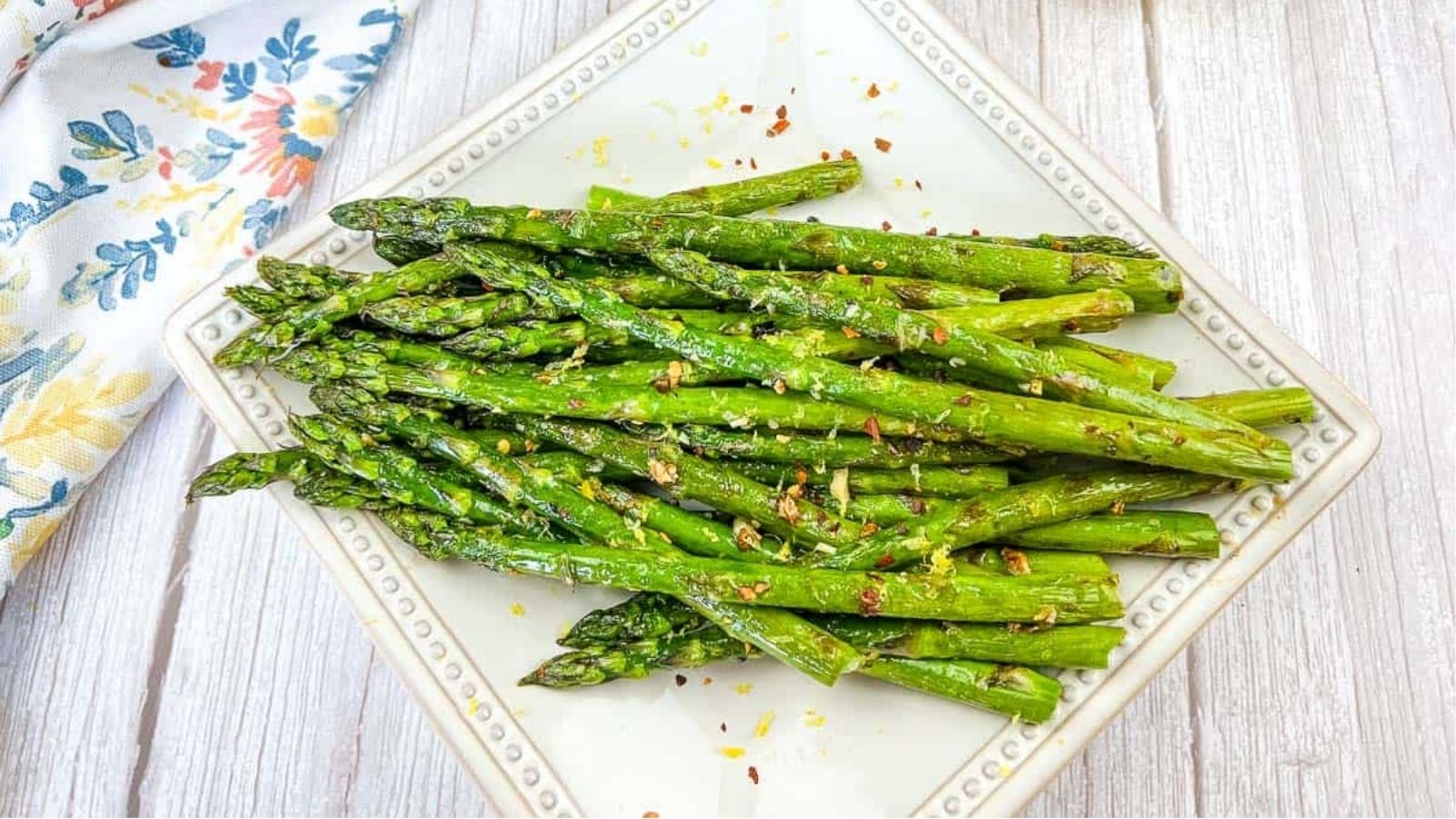Grilled Asparagus on a white square plate.