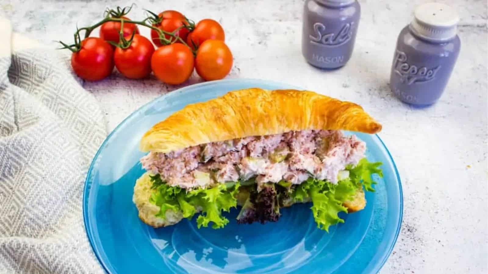 Ham Salad with dill pickle on a plate.