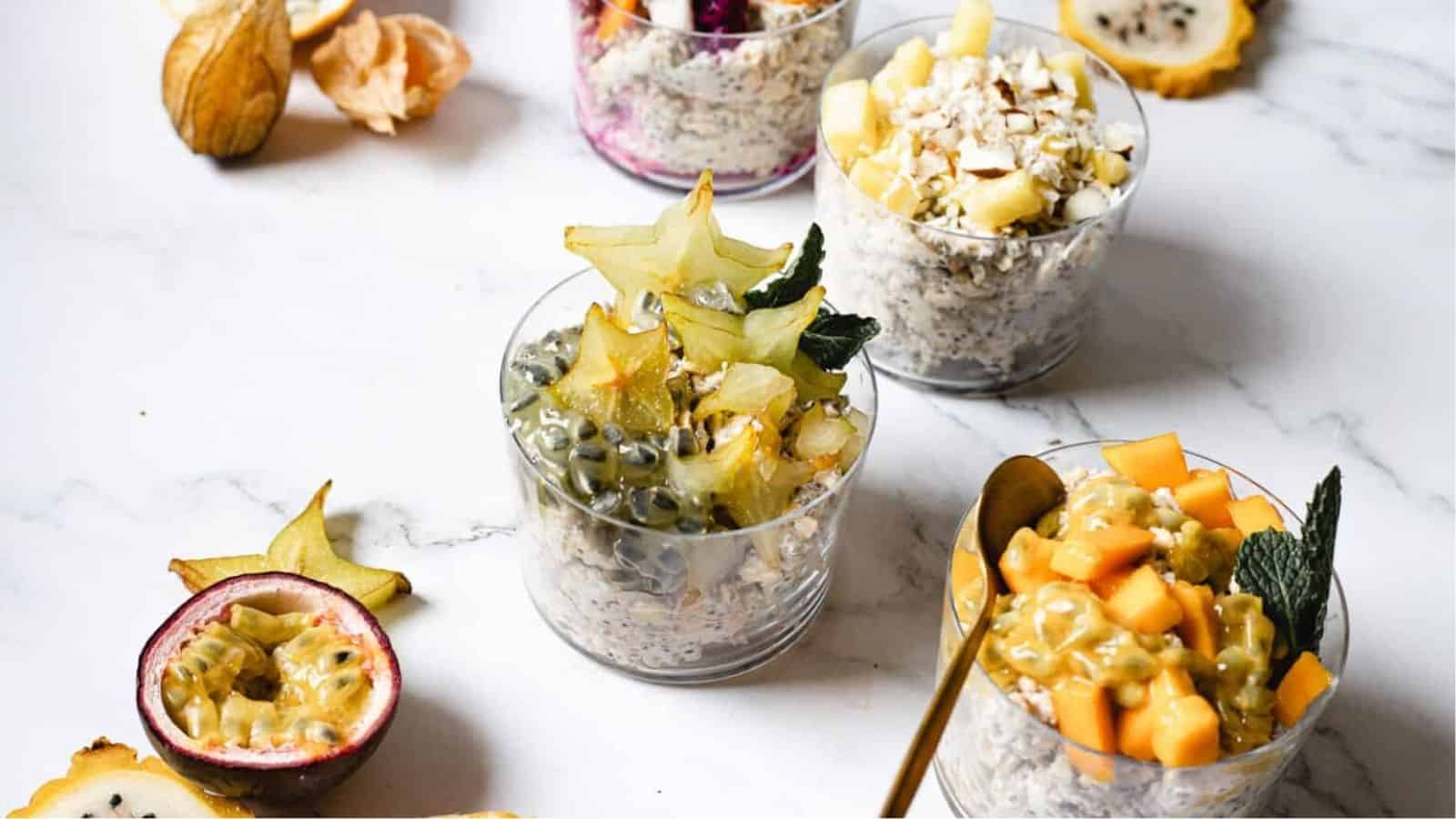 Close-up image of overnight oats with tropical fruit in glasses.