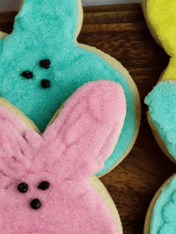 Peeps Sugar Cookies with Marshmallow Creme Frosting on a board.