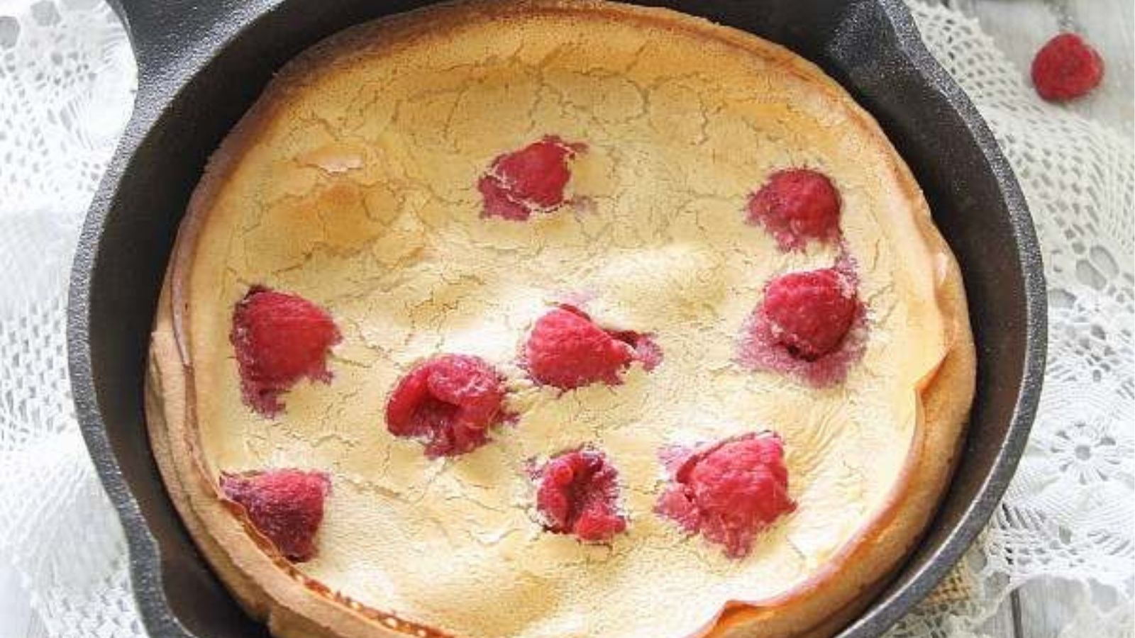 Close-up image of raspberry lemon dutch baby.