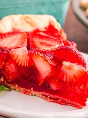 A slice of Strawberry Jello Pie on a stack of two plates.